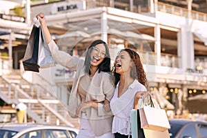 Woman, friends and excited with shopping bag in city for retail fashion with discount, deal or promotion. Female people