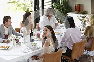 Woman With Friends Having A Dinner Party At Home