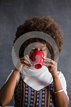 Woman with frizzy hair drinking coffee