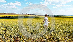 Woman frolicking in a field of flowers in spring