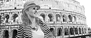 Woman in front of Colosseum in Rome looking into distance