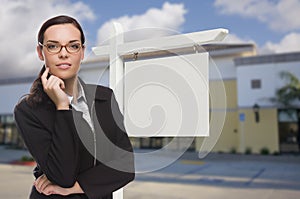 Woman In Front Commercial Building and Blank Real Estate Sign