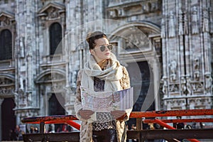 Woman in front of Duomo in Milan with map looking into distance