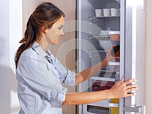 Woman in front of the fridge