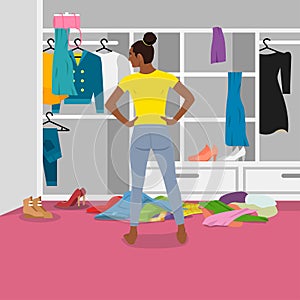 Woman in front of messy untidy wardrobe. Mess and chaos in open closet. Person looking inside cupboard with lot of cluttered,