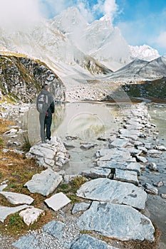 A woman in front of a mountainous lake