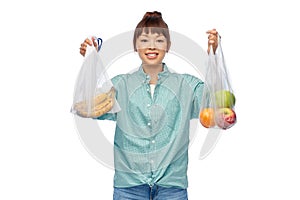 woman with fruits in reusable and plastic bags