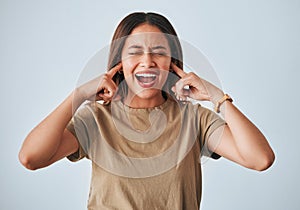 Woman, frustrated and fingers in ears, studio background and shouting with anger, annoyed and problem. Student girl