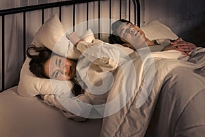 woman frustrated by partner's snoring during a restless night