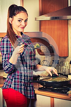 Woman frying frozen vegetables. Stir fry.