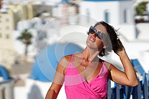 Woman with Fuchsia dress admires the Oia Scenery in Santorini