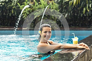 Woman with fuit drink in pool