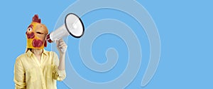 Woman in funny chicken mask making announcement with megaphone on copy space banner background