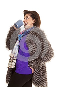 Woman fur coat drink from mug