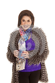 Woman fur coat hold mug both hands smile