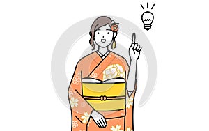 Woman in furisode coming up with an idea photo