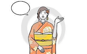 Woman in furisode giving directions, with a wipeout photo