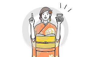 Woman in furisode holding a calculator and pointing photo