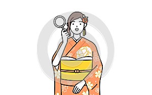 Woman in furisode looking through magnifying glasses photo