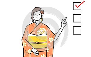 Woman in furisode pointing to a checklist photo