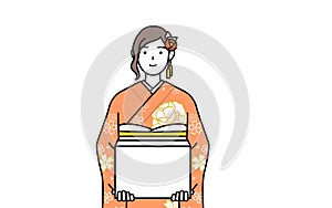 Woman in furisode working to carry cardboard boxes