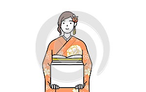 Woman in furisode working to carry cardboard boxes photo