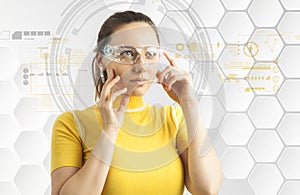 Woman in futuristic background with virtual holographic glasses