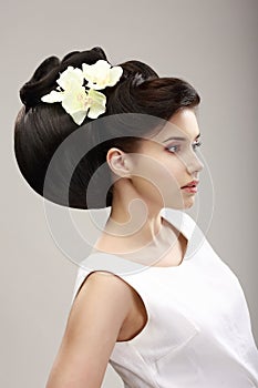 Woman with Futuristic Hairstyle and Orchid photo