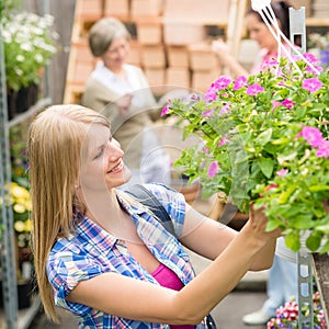 Woman at garden centre shopping for flowers