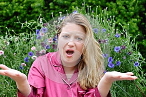 Woman in garden gesturing