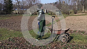 Woman gardener with back pain on field