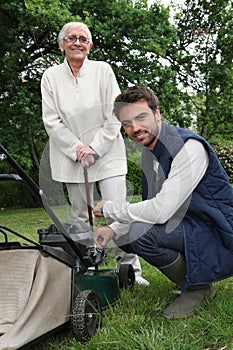 Woman with gardener and lawnmower