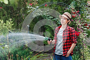 Woman gardener watering garden