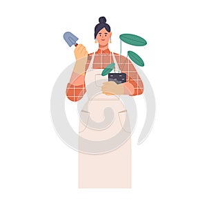 Woman gardener at work. Female portrait with potted house plant and shovel. Professional botanist in apron growing and