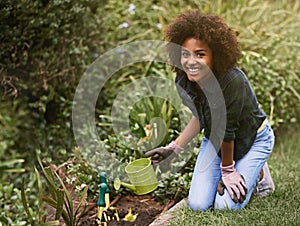 Woman, gardening and water can on ground with smile for plants in spring, outdoor or care on grass. Girl, African person