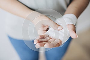 Woman with gauze bandage wrapped around her hand