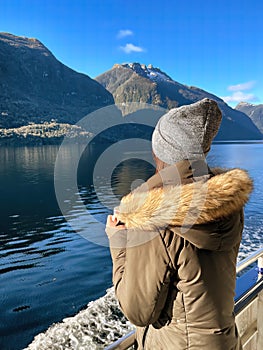 A woman gazes at Doubtful Sound from a cruise in South Island, New Zealand