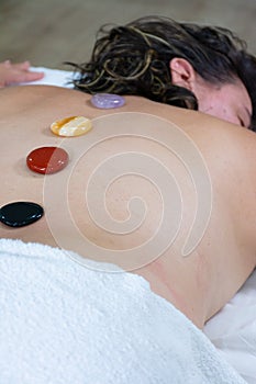 Woman with gem treatment on her back