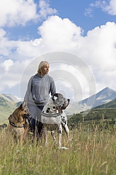 Woman, german sheperd and great dane