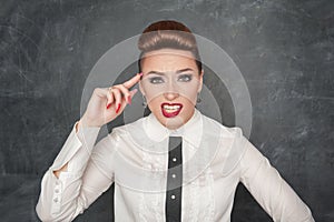 Woman gesturing with finger to her head