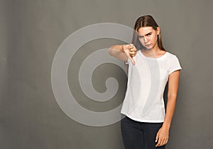 Woman gesturing thumb down sign