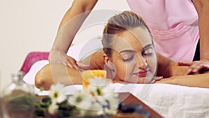 Woman gets back massage spa by massage therapist.