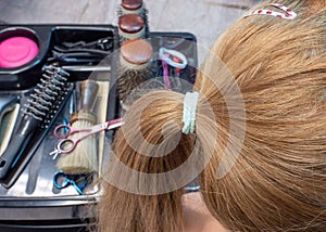 Woman gets a braid done in the hair salon