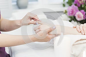 Woman gets hand massage in spa salon. Hand skin care procedures. Relaxing massage in beauty salon