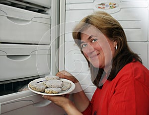 Woman gets out of refrigerator frozen meatba