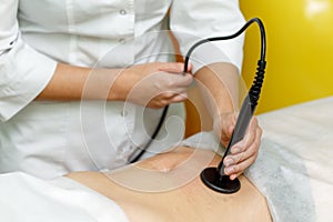 Woman getting anti cellulite therapy in beauty salon. RF lifting