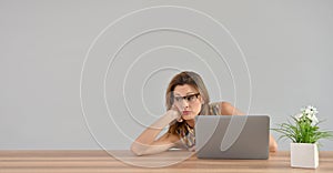 Woman getting bored in front of laptop
