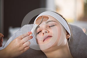 Woman getting chocolate mask treatment in spa