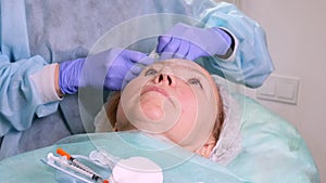Woman getting cosmetic injection of botox, closeup. Woman in beauty salon. plastic surgery clinic