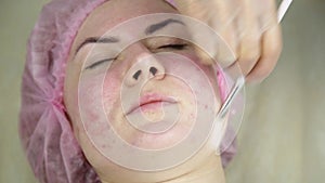 Woman getting a cosmetic medicine treatment, cleaning face skin with mask